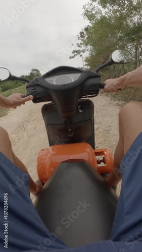 POV. Ride moped with propane tank on dirt road.