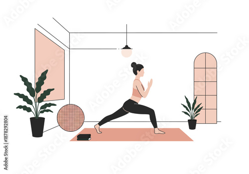 Woman practices a yoga warrior pose at home embracing health and well-being in a calm modern space.