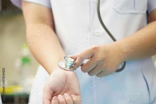 Medical Staff Checking Radial Pulse with Stethoscope