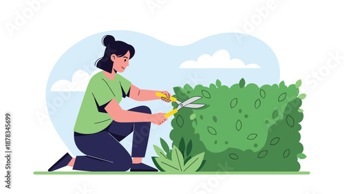Focused woman in a green shirt and dark pants uses large shears to trim a green garden hedge on a sunny day with white clouds.