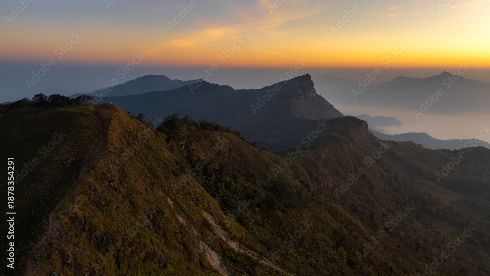 Obraz premium defaultA picture of high mountains covered in morning mist.