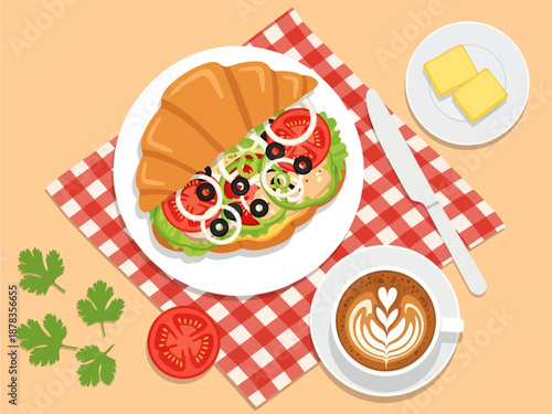 A savory croissant sandwich filled with tomatoes, olives, and onions sits on a checkered napkin beside a frothy heart-topped latte and butter pats, depicting a charming picnic-style breakfast feast