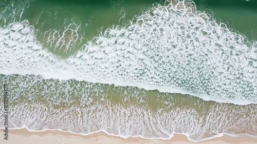 Aerial View of Ocean Waves Crashing on a Sandy Beach