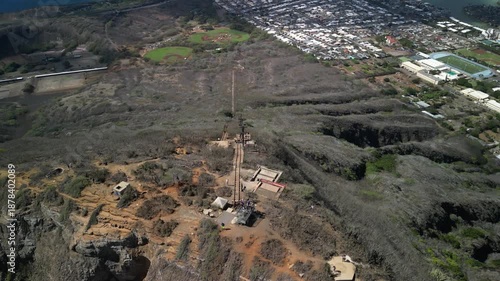 Aerial drone view of koko head crater summit lookout and hiking trail overlooking honolulu neighborhoods and coastline in hawaii
