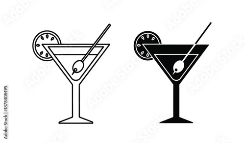 Two black and white martini glasses with lime wedges and stirrers on a pure