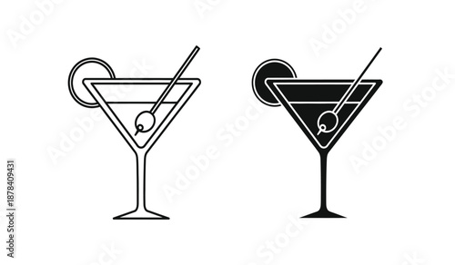 Two black and white martini glasses with olives and cocktail sticks
