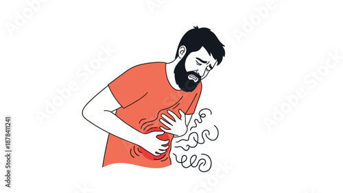 Bearded man in a red shirt clutches his stomach in pain while suffering from indigestion, stomach ache, or abdominal cramps.