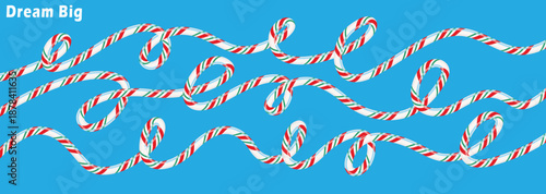 Wavy lines of festive candy canes with inspiring 'dream big' text on a vibrant blue background