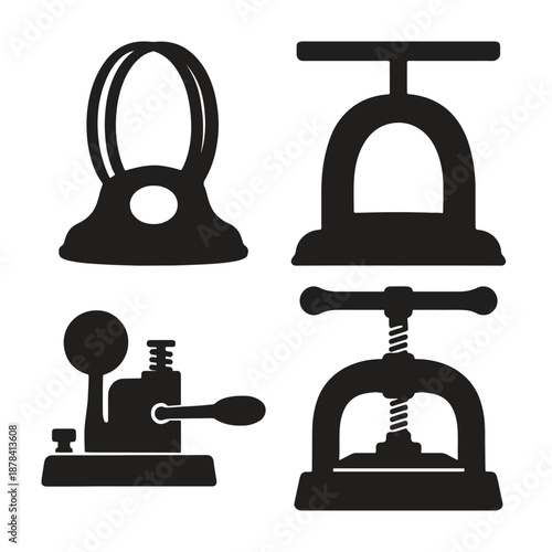 Black silhouettes of vintage hole punchers and paper cutters