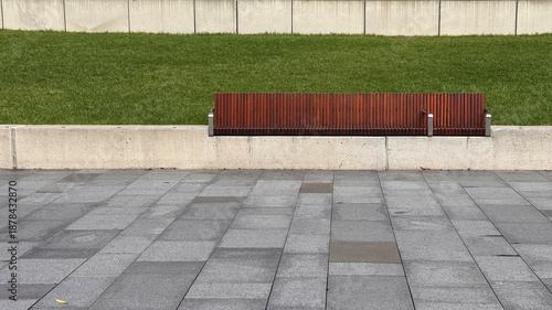 empty wooden bench built on retaining wall in the park