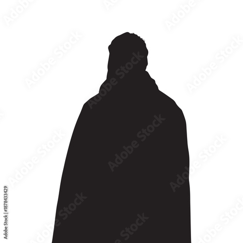 Mysterious silhouette of a person in a dark coat against a bright background