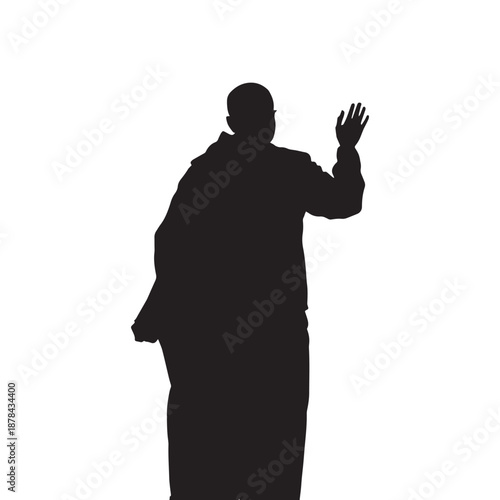 Man in silhouette waving against mosque skyline at sunrise