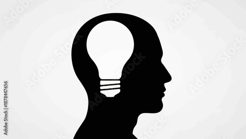 Silhouette of a human head with a glowing light bulb inside, symbolizing ideas