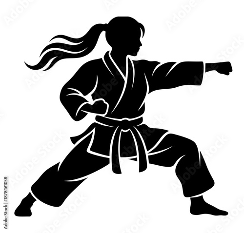 Karate fighter silhouette showing a woman performing a forward punch in a strong martial arts stance.