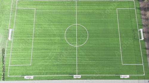 View from the top of the green soccer field with artificial turf and practice gates on the sides. Soccer field goal. High quality 4k footage