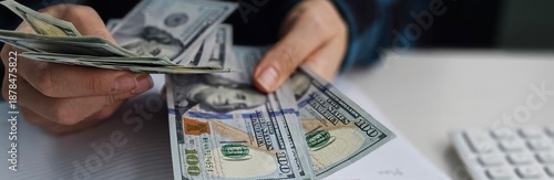 Counting cash and making financial notes in a workspace during the daytime concept