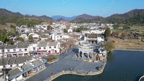 Xidi, China: Aerial drone footage of the famous Xidi ancient village with its famous paifang, a memorial archway, near Huangshan in Anhui province in China. 