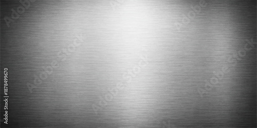 Polished silver stainless steel plate with a brushed metal texture featuring a shiny industrial grey aluminum surface pattern for a metallic titanium sheet backdrop
