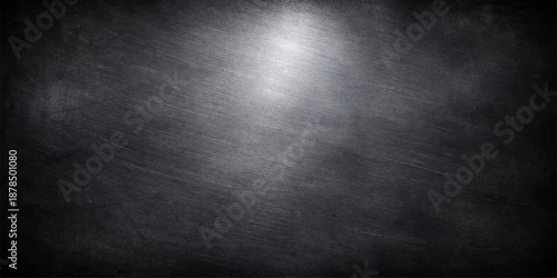 Dark metal background with light highlighting a grunge steel texture and vintage metallic wall surface for a blank silver plate backdrop