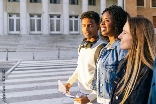 Diverse group of college students walking outdoors near a university building, representing modern education and friendship