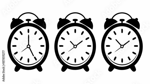 Three alarm clocks displayed together showing different times on a plain background from a straightforward viewpoint