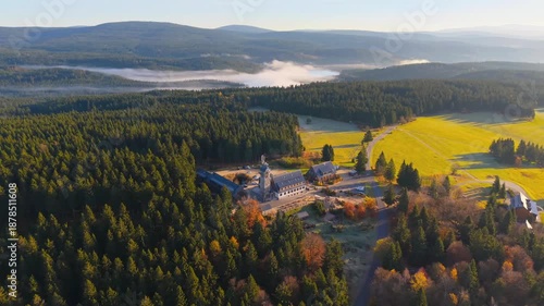 Discover Kralovka lookout tower surrounded by vibrant autumn colors in the Jizera Mountains. Experience breathtaking views of forests and misty valleys. Enjoy this tranquil nature getaway.