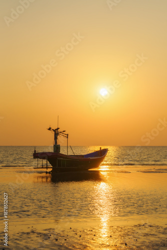 Fishing boats on the beach when the sun begins to set with a beautiful backdrop of sea and sand.