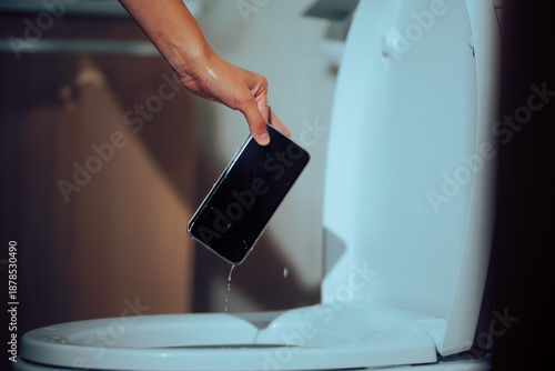Obraz na płótnie Person Takes Out Wet Smartphone from Toilet