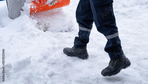Municipal workers are cleaning the sidewalks blocked by snow. snow removal workers with snow shovels