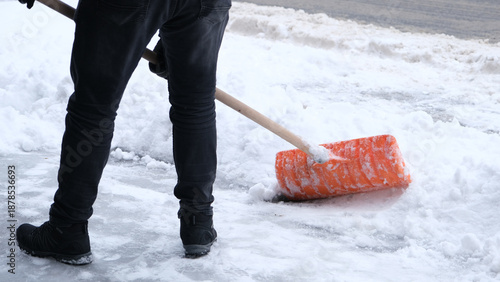 Municipal workers are cleaning the sidewalks blocked by snow. snow removal workers with snow shovels