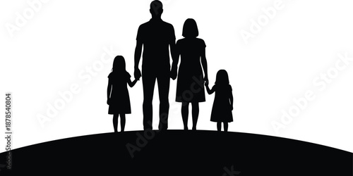 A family of four standing together on a hill