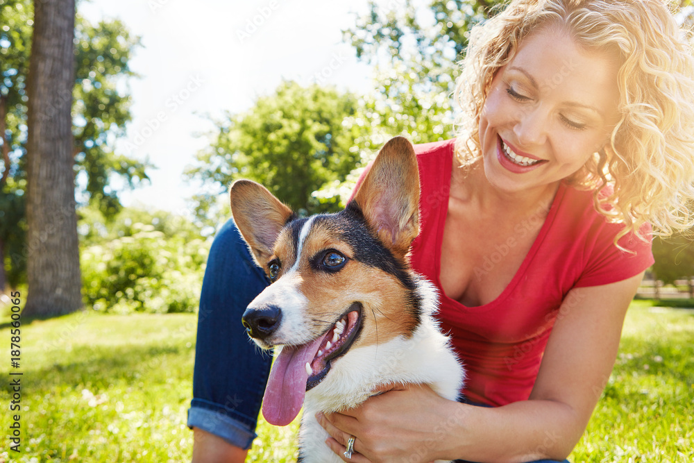 Fototapeta premium Smile, love and dog with woman in park for connection, bonding and animal adoption. Pet care, loyalty and happiness with person and welsh corgi outdoor for protection, relax and canine companion