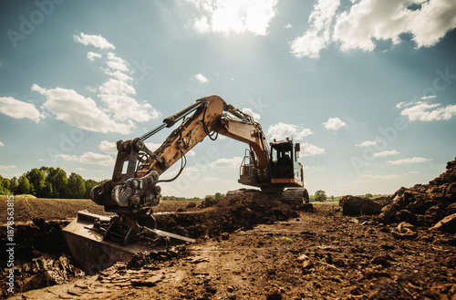 Foto Low angle view of excavator at construction site with dramatic sky