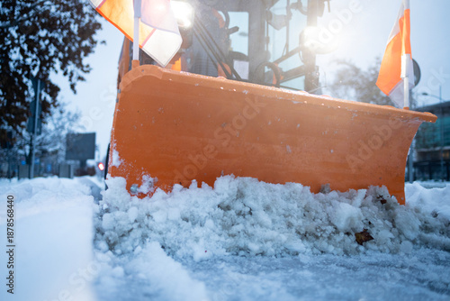Snow plow clearing road surface during winter