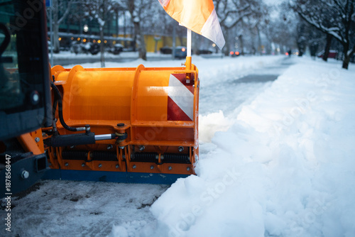 Canvas-taulu Orange snow plow clearing street after winter blizzard