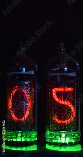 Vertical 4K footage of a timer's retro tubes count down 10 seconds, glowing vividly on an acid green base that highlights its nostalgic design.