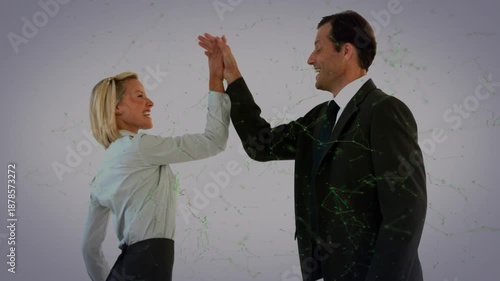 Two businessmen are shown high-fiving each other in slow motion