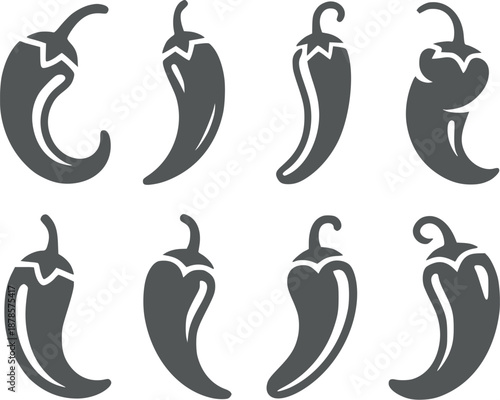 Eight dark gray pepper in various shapes and orientations