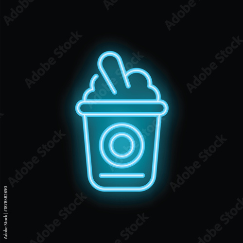 Bright turquoise neon sign of a milkshake in a plastic cup with whipped cream and a straw, isolated on a black background