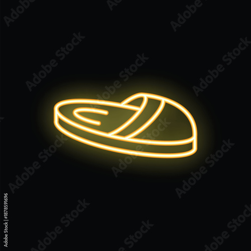 Golden neon sign illuminating a pair of slippers on a black background