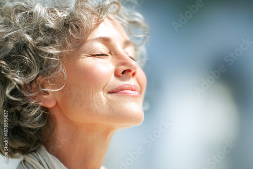Elderly woman enjoying a moment of peace in natural light outdoors Generative AI