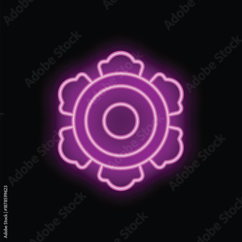 Purple neon sign in the shape of an abstract flower is glowing on a brick wall