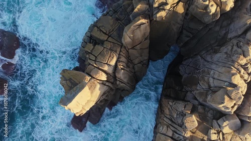 Sea Waves On Cantís de Papel Granite Rocks At Sunset Near Xove In Lugo, Galicia, Spain. Aerial Topdown Shot