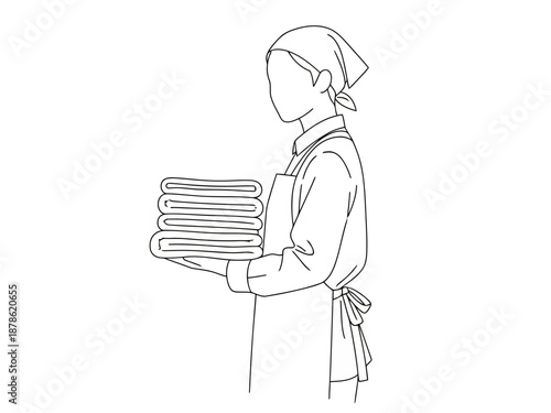 A woman carrying a stack of towels for cleaning or laundry concepts
