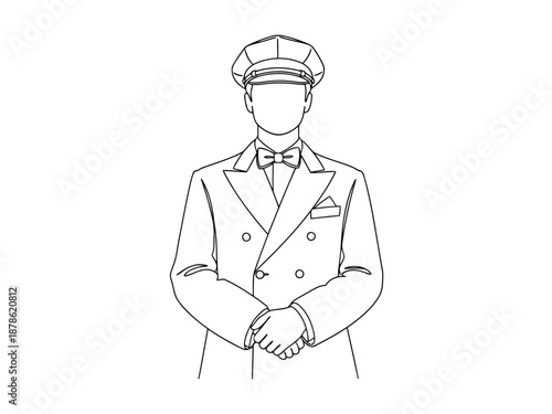 A man wearing a double breasted coat and a cap standing still