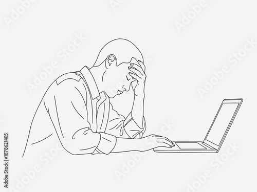 Man sitting at a laptop with his hand on his forehead stressed