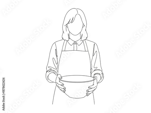 Woman wearing an apron holding a bowl in both hands