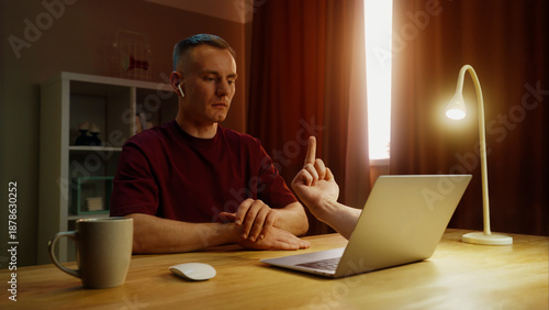 Fényképezés Man see middle finger remote, obscene hand fuck you off gesture from laptop screen