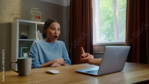 Woman see middle finger remote, obscene hand fuck you gesture from laptop screen. Person visit suspicious phishing scam website. Online gambling fail. Work failure. Funny joke, humor. Internet fraud.