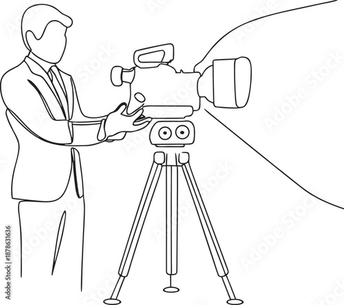 man in suit operating large video camera on tripod stand